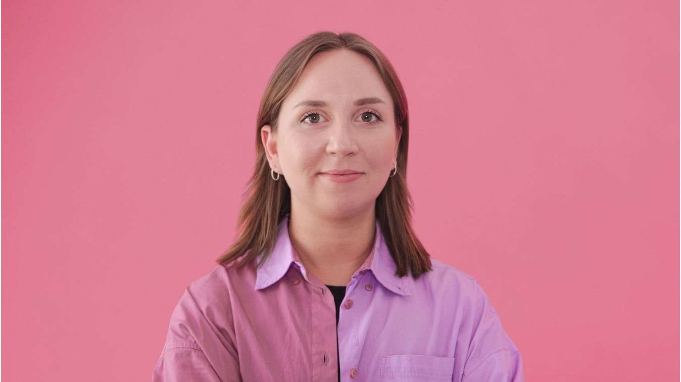 Woman smiling pink background